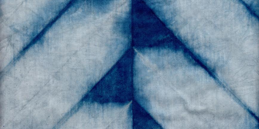 Indigo dyed fabric printed in a white chevron pattern