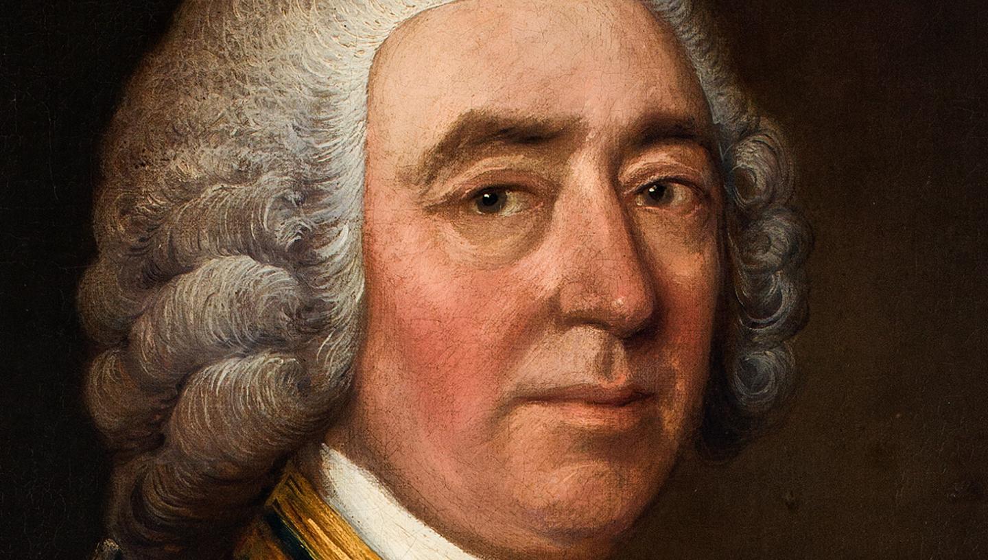 A close up view of a painting of a naval commander, showing the portrait sitter's face. He is wearing a curly grey wig and looking directly at the viewer with a steady gaze