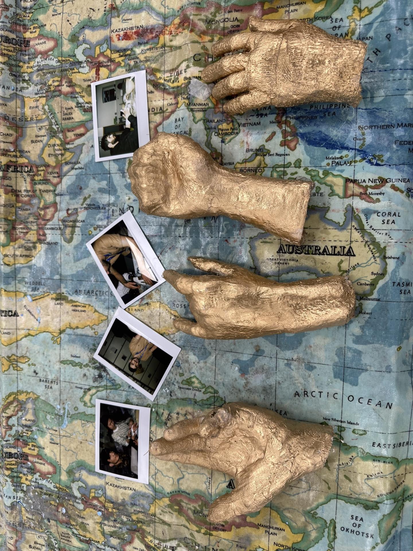 gold hands with photos