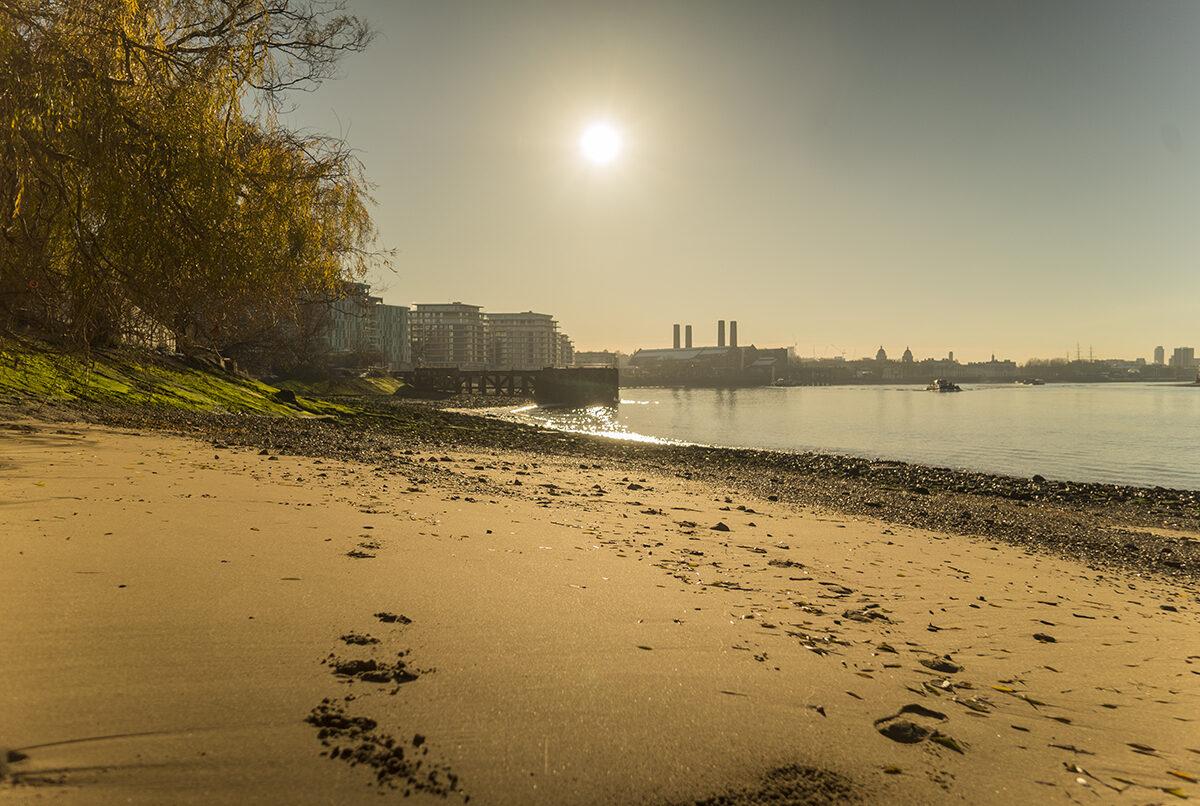 Image from Thames foreshore which resembles a beach, looking towards the pier at Enderby Wharf