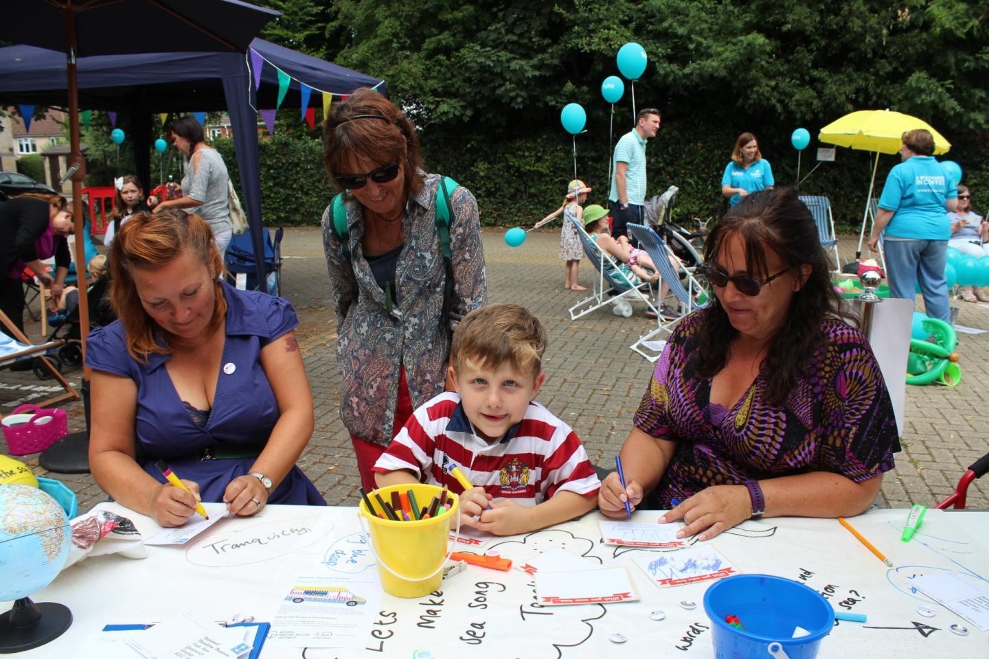 Participants engaging with the Maritime Memories Machine by drawing their connection to the sea at Sailors' Society, Southampton.