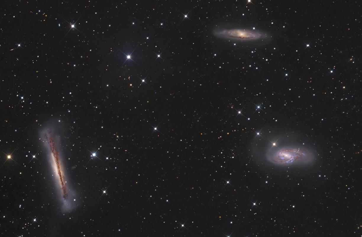 A photograph of three galaxies in the night sky