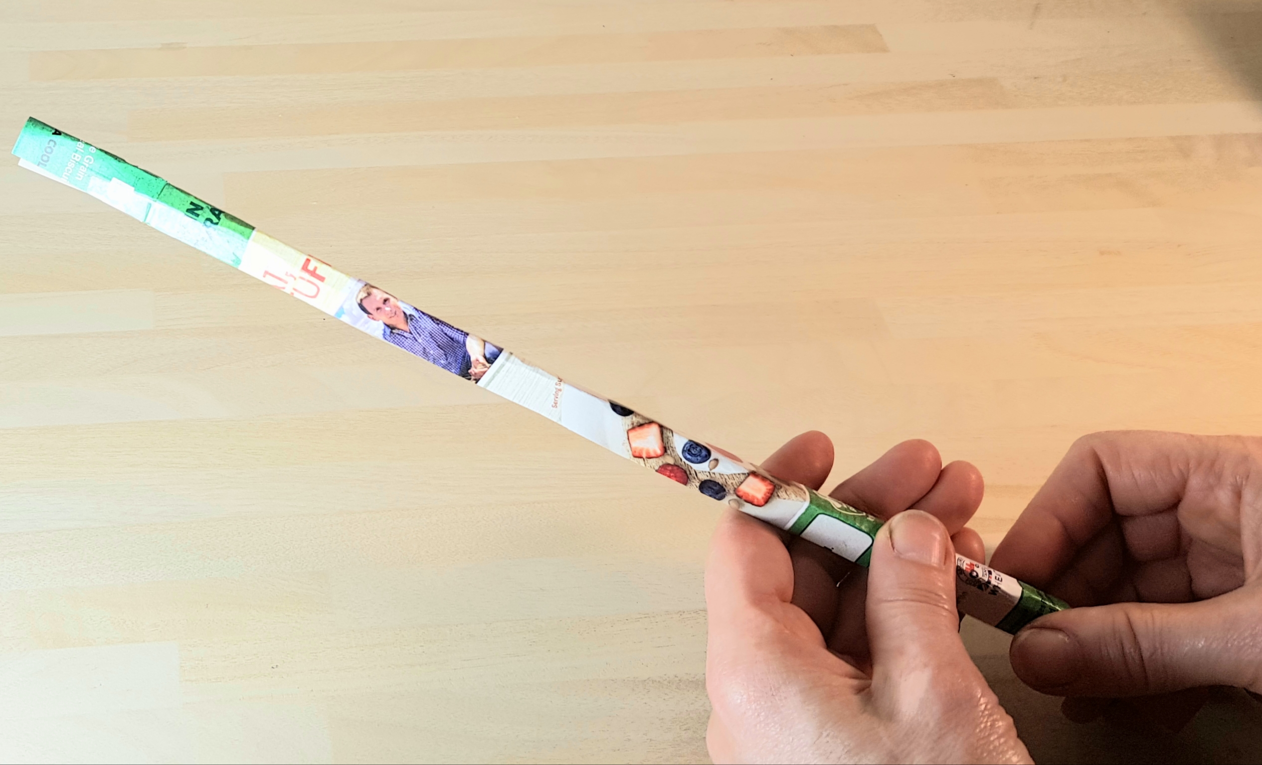 Create rolled tubes for your masts. Paper has been rolled up into a long, thin tube and secured using tape.