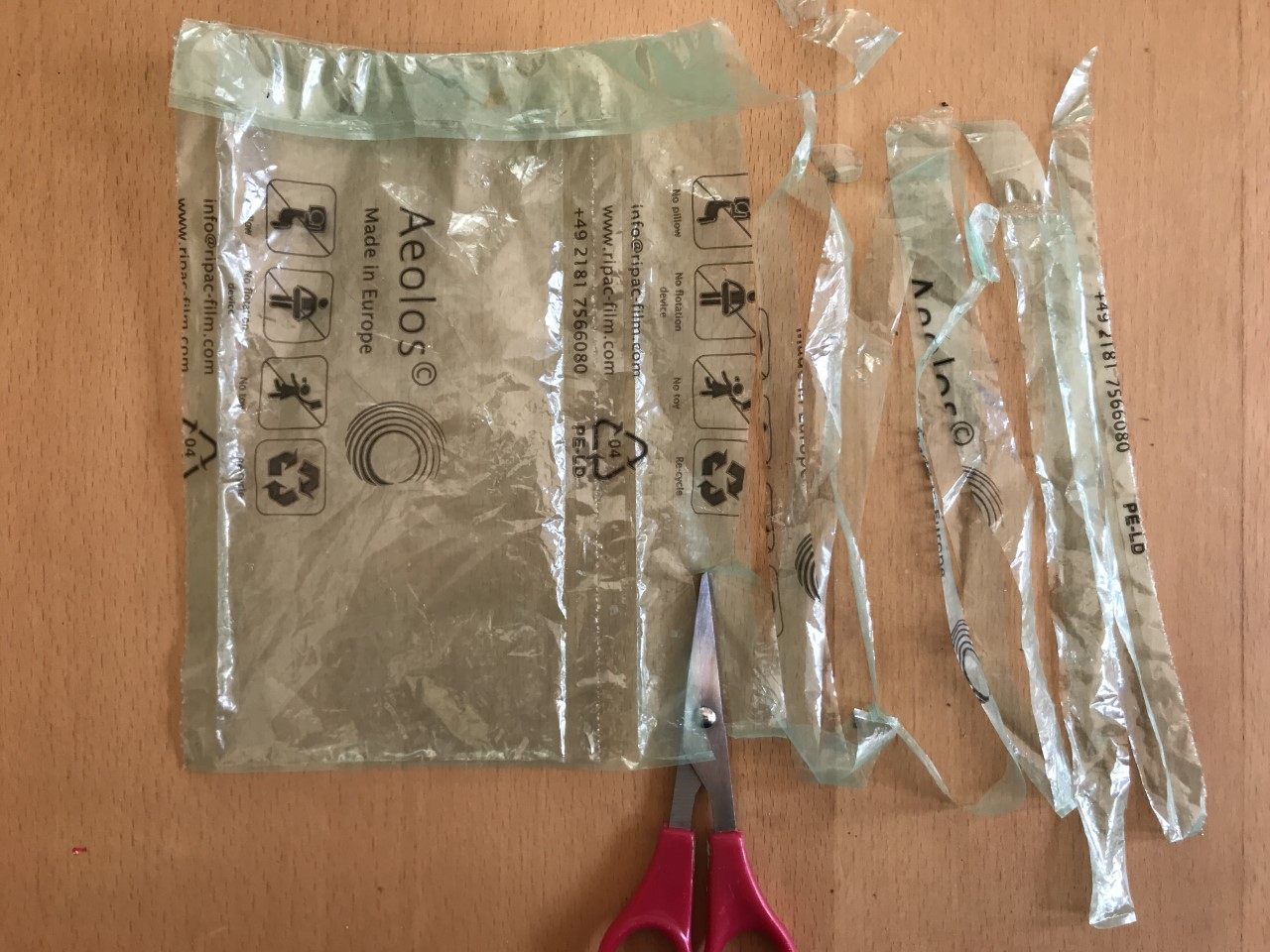 Cut your plastic bag into strips Plastic bag cut into thin strips using scissors