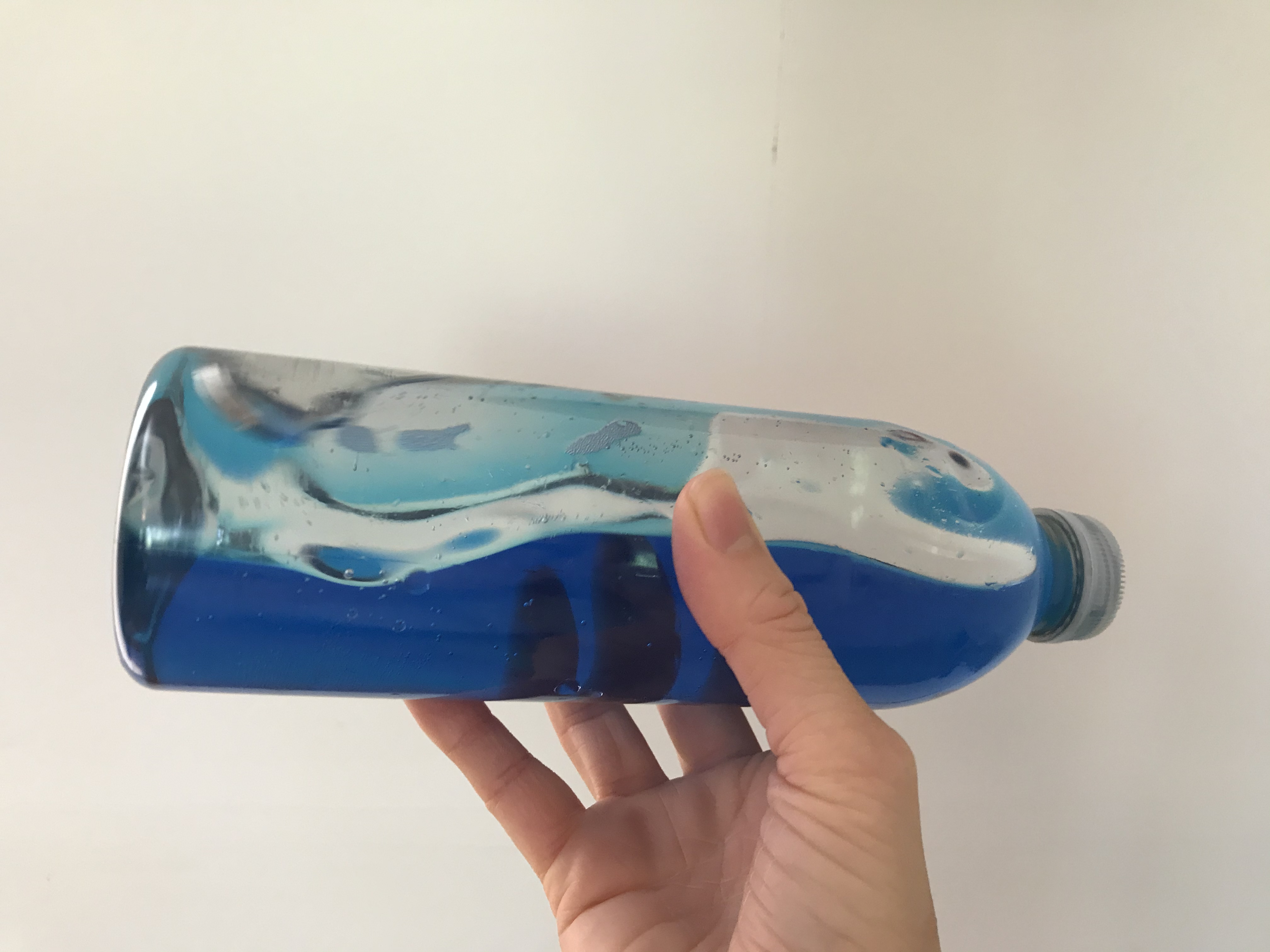 Ocean in a bottle A water bottle made to look like it has waves inside using blue water and oil.