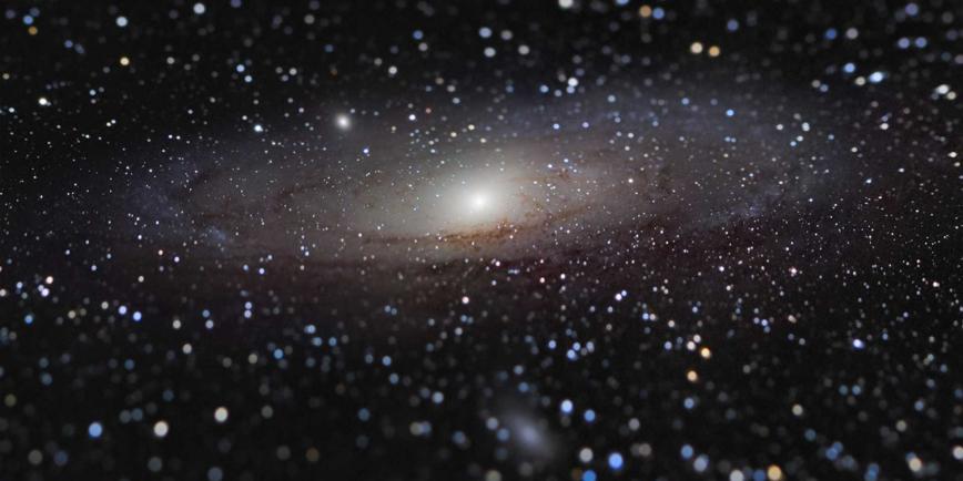 Photo of the Andromeda Galaxy - a dark black sky sprinkled with stars