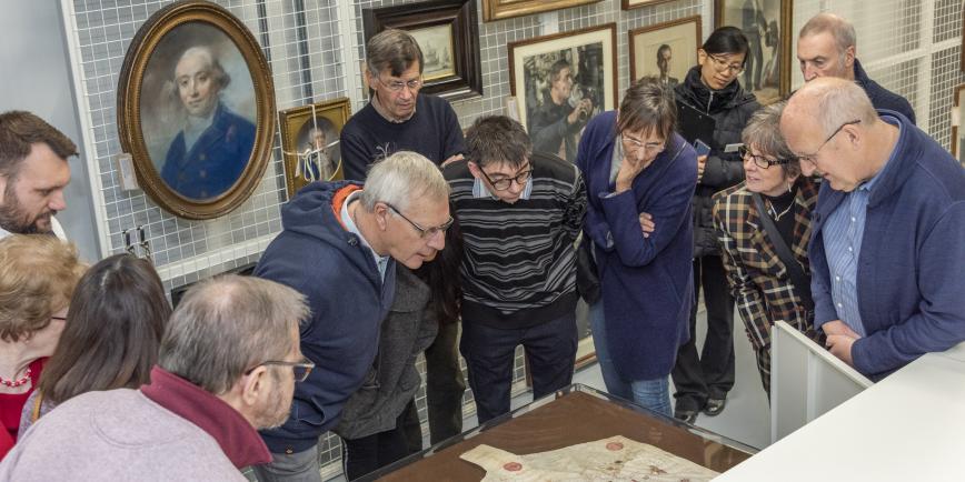 Participants viewing the oldest portolan chart in the National Maritime Museum's collections from 1456.