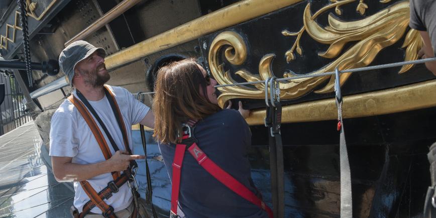 Man and woman looking at gingerbread on cutty sark