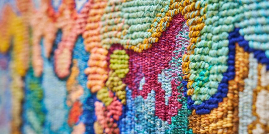 Detail of colourful woven coral borders on a tapestry