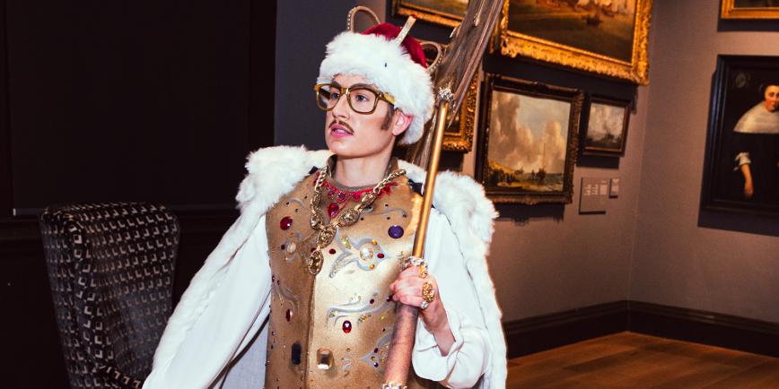 Drag King Adam All in regal costume striding through the Queen's House