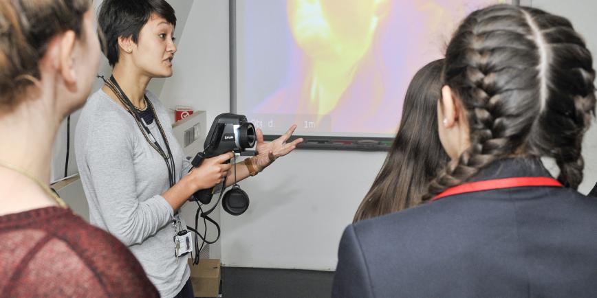 A teacher demonstrates a special type of video camera to students
