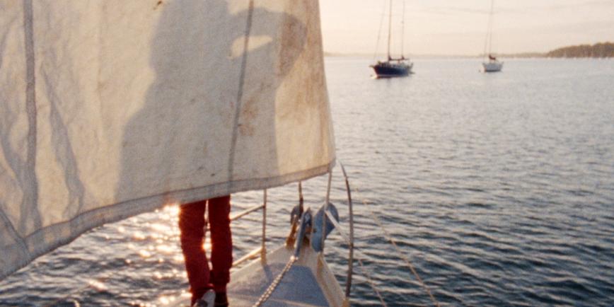 An image of a man in red trousers on a yacht