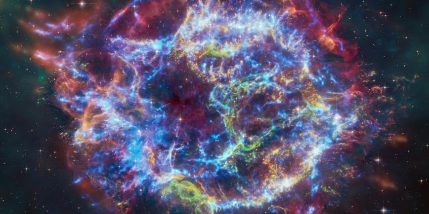 Image of Cassiopeia A nebula, which resembles an explosion in waves of different colours