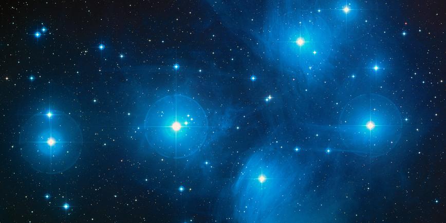 A close-up telescope view of the bright blue star cluster known as the Pleiades