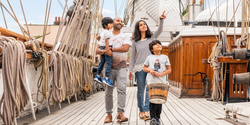 A family walks along the Main Deck of Cutty Sark