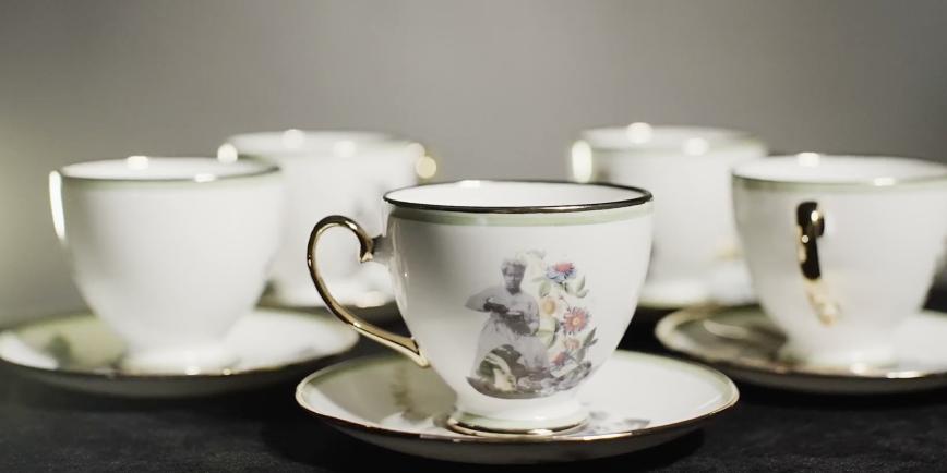 Tea cups adorned with images of women and flowers