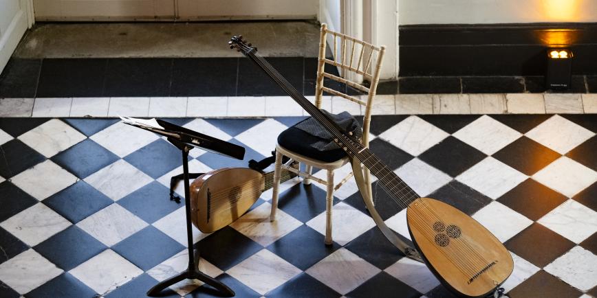 Image of two lutes against a black and white marble floor