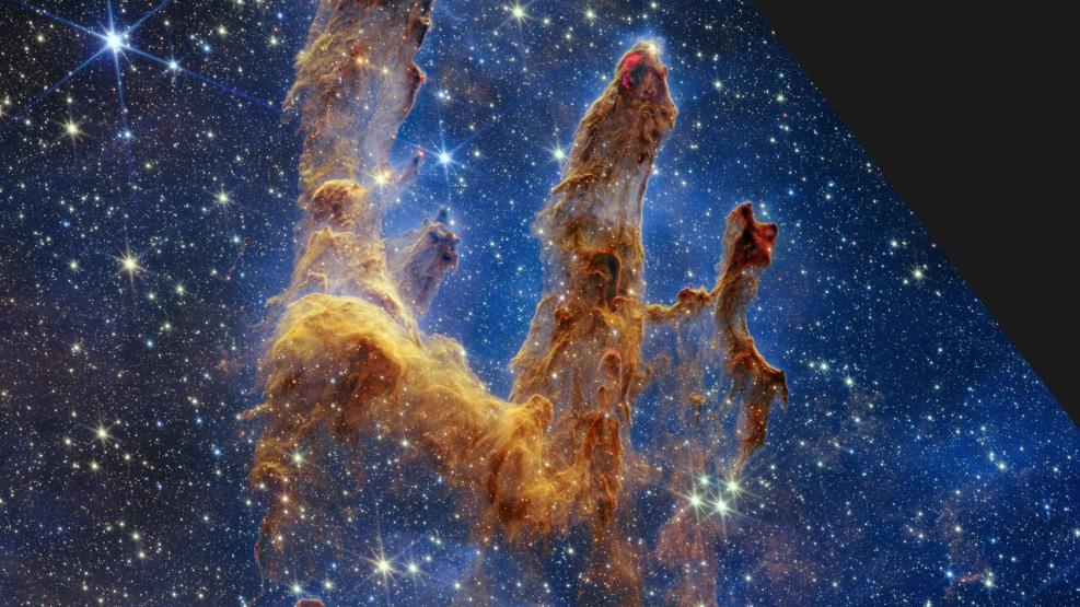 Image of nebula (gas and dust) in shape of 'pillars' which look like a human hand with fingers, in gold and yellow tones. The image is studded with hundreds of stars