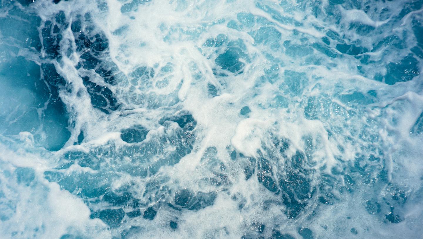 A close up view of ocean waves with white surf