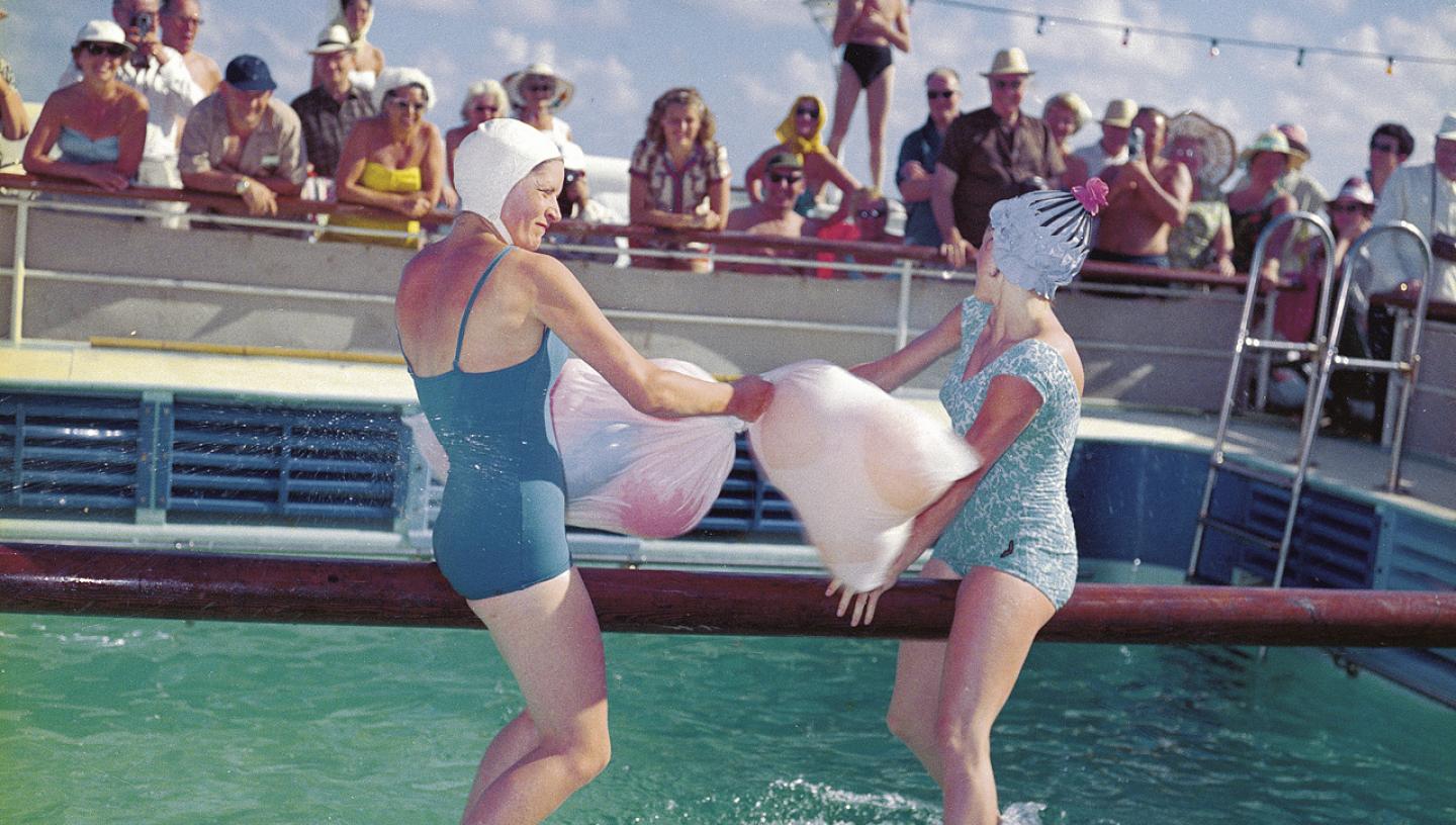Two ladies in swimming costumes in the "Greasy Pole" competition aboard the 'Empress of Canada' (1961)