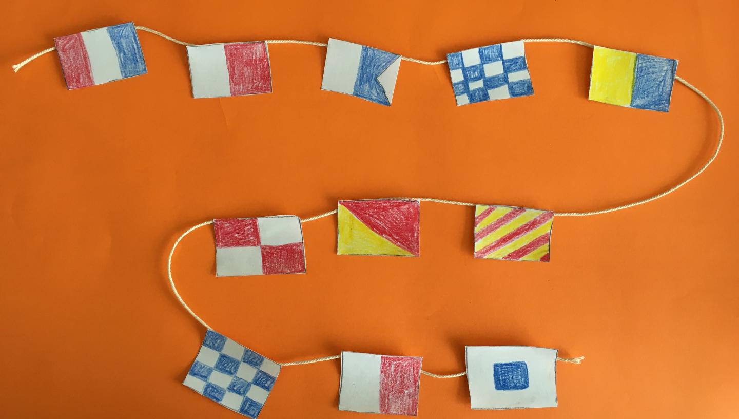 hand drawn signal flag message on a string