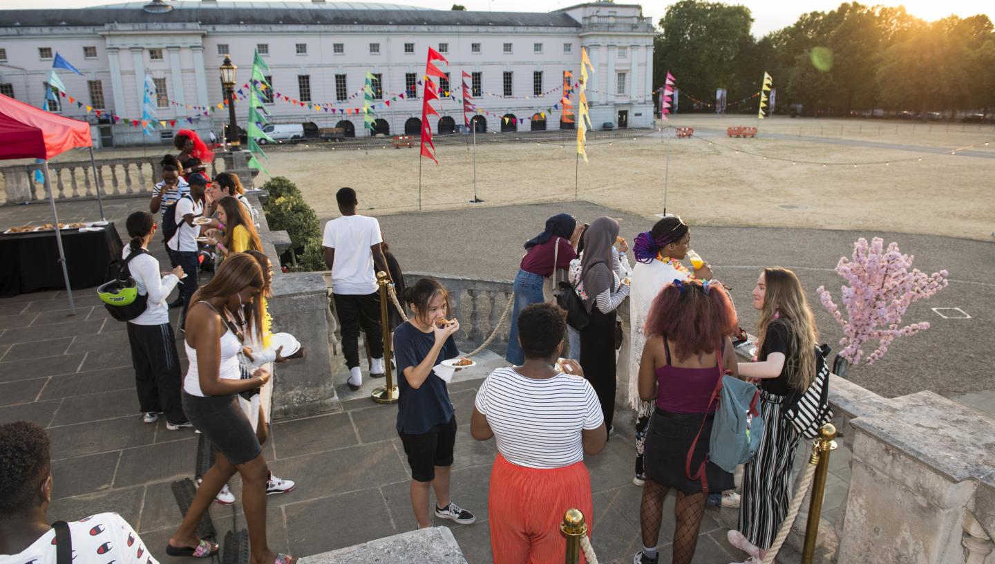 Young people at an evening event on balcony of the Queen's House in Greenwich