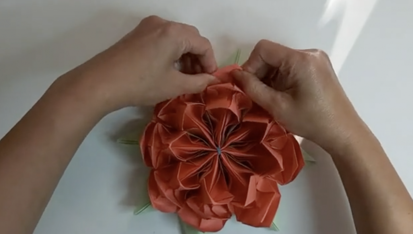 An orange origami flower. 