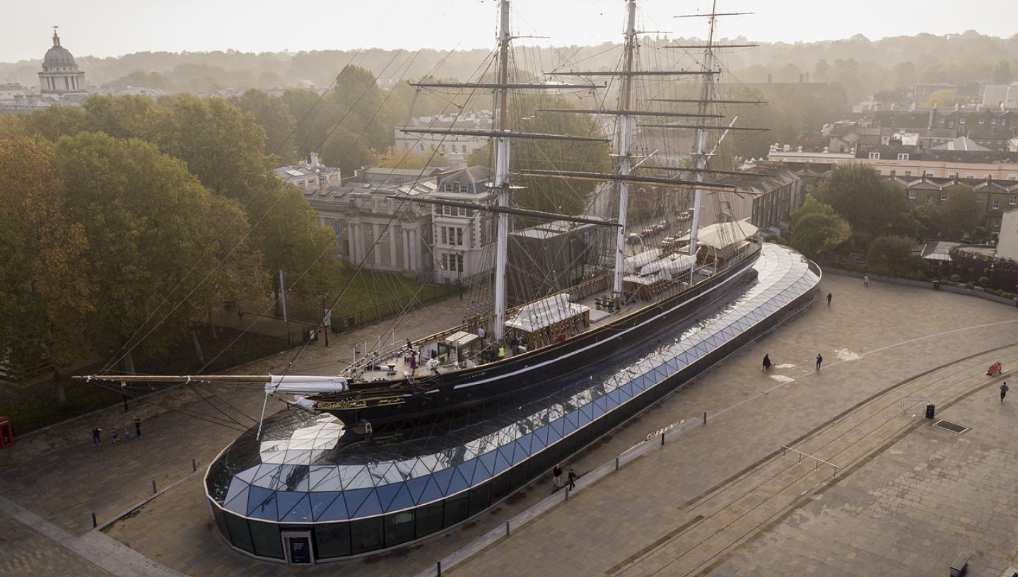 A drone image of Cutty Sark with Greenwich Park in the distance