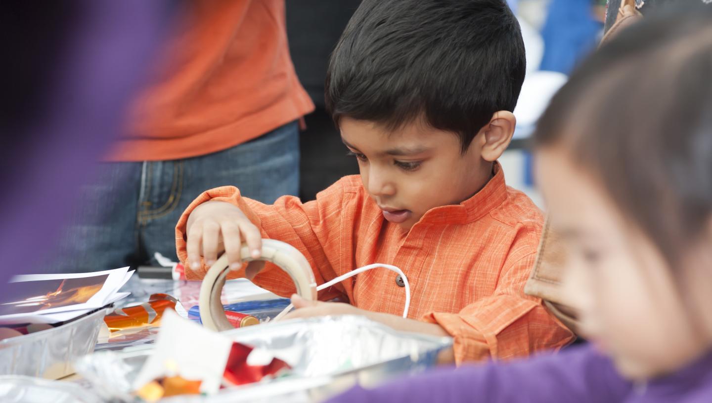 Child participating in craft activity.