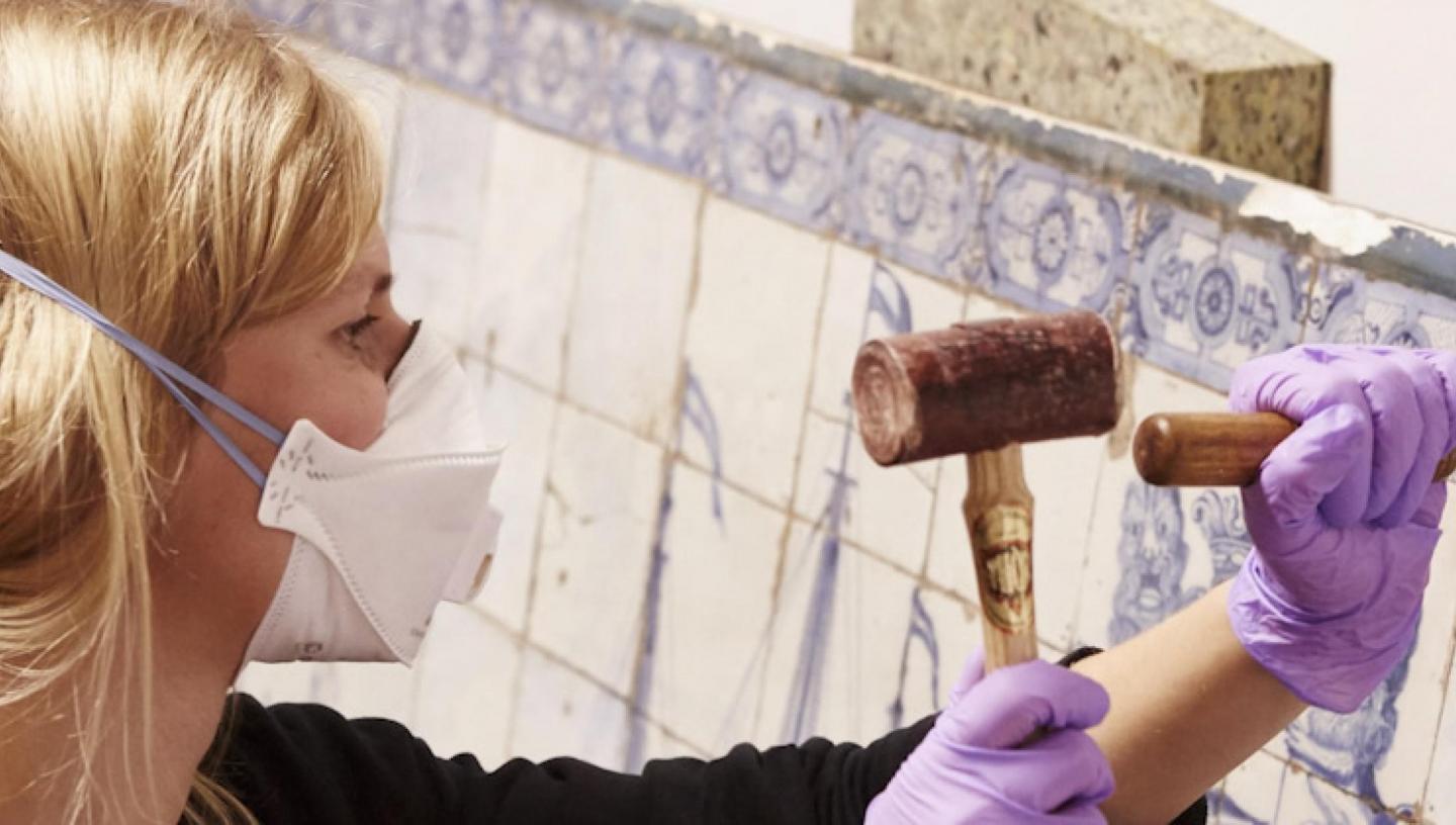 A woman performing ceramics conservation