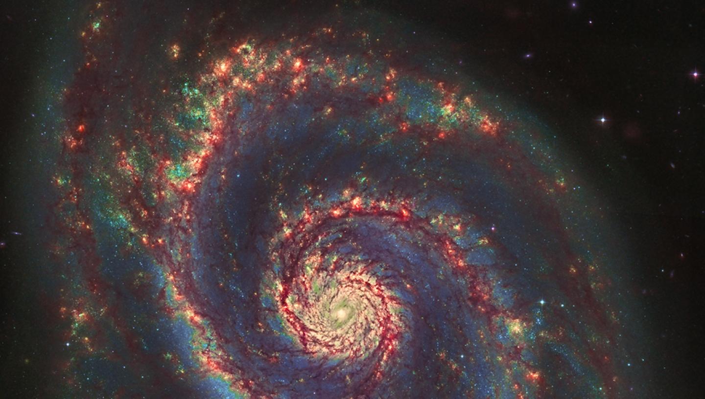 Astronomy photograph of the 'Whirlpool Galaxy', with a spiral of stars at the centre