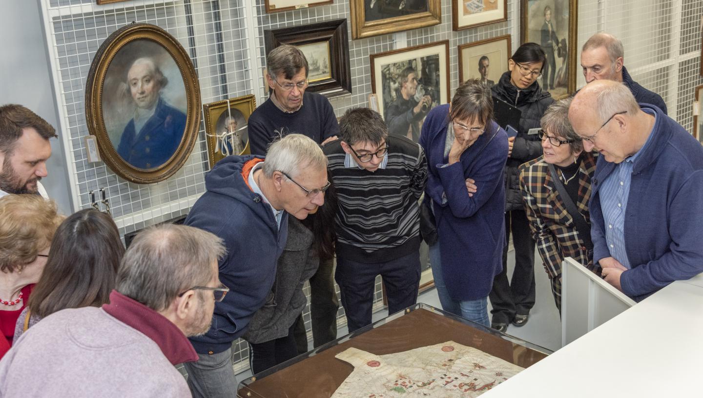 Participants viewing the oldest portolan chart in the National Maritime Museum's collections from 1456.