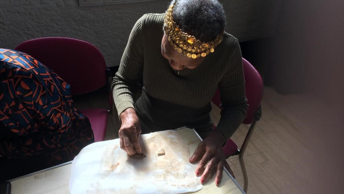 Participant in a workshop creating art pieces