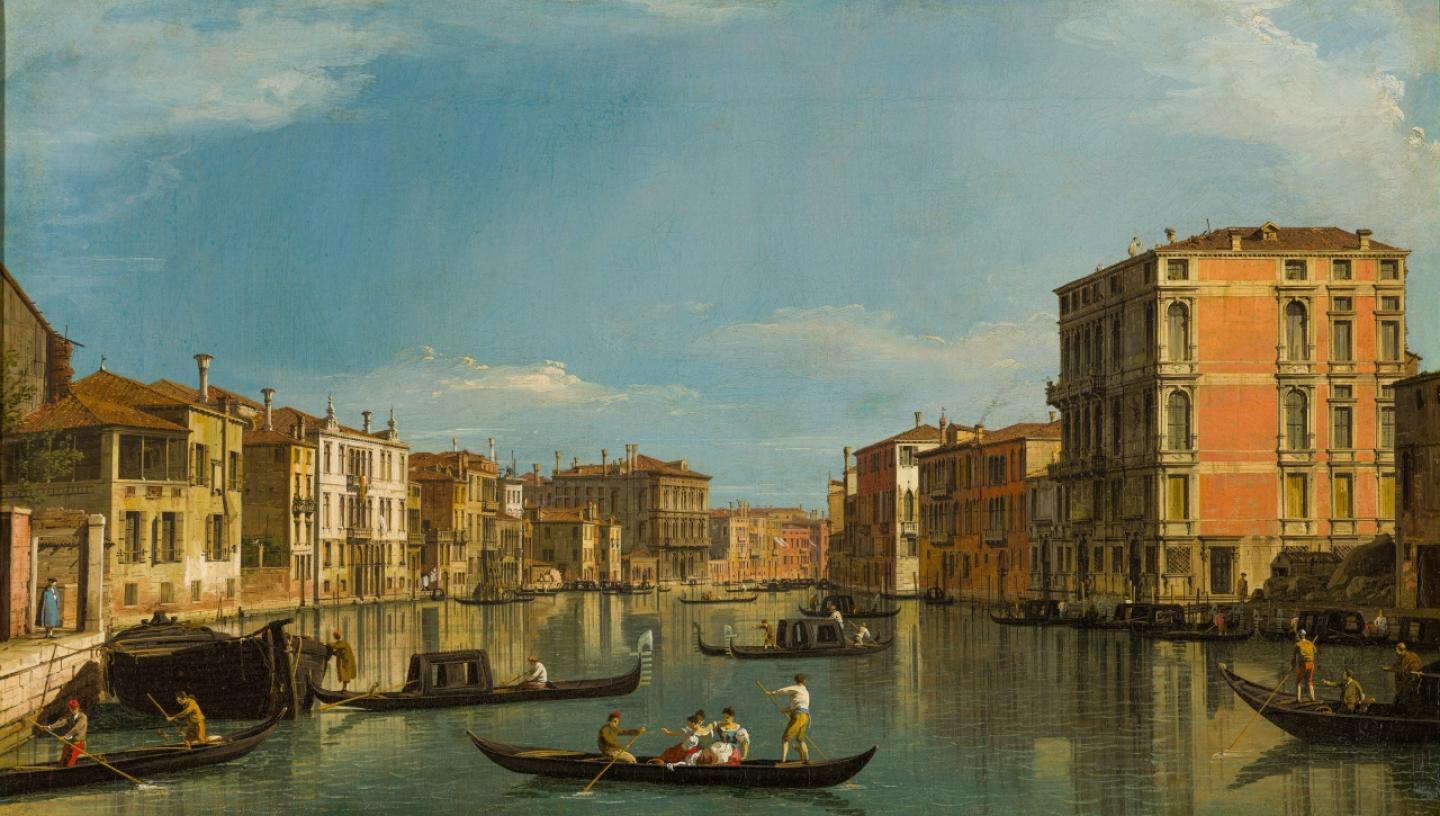 A painting of the Grand Canal in Venice by Canaletto. Gondolas dominate the foreground, with palaces and buildings lining the canal