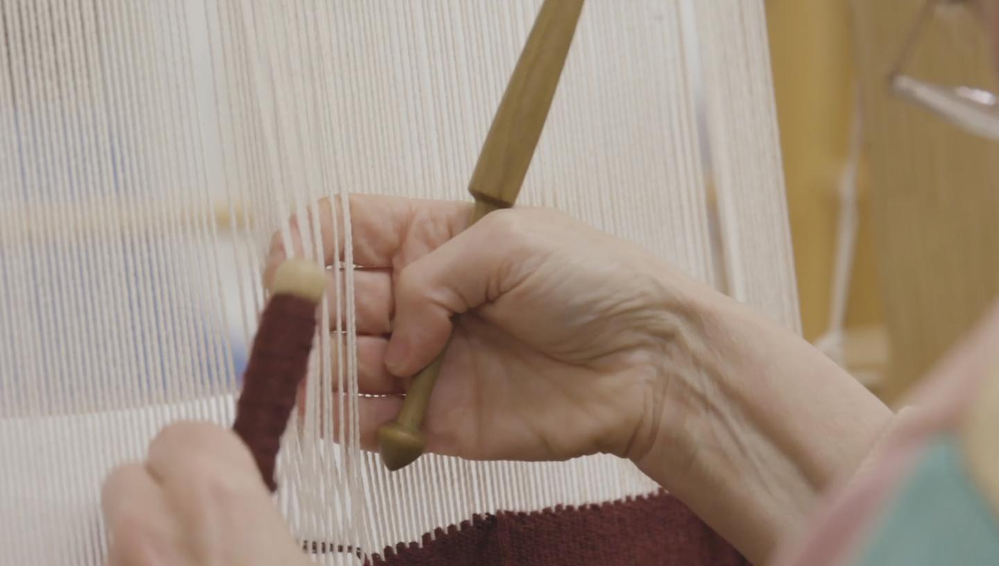 Detail of threads being woven into a tapestry