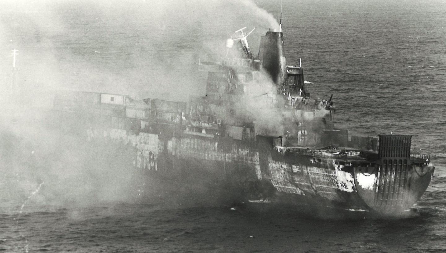 Black and white photograph of a ship on fire in the Falklands