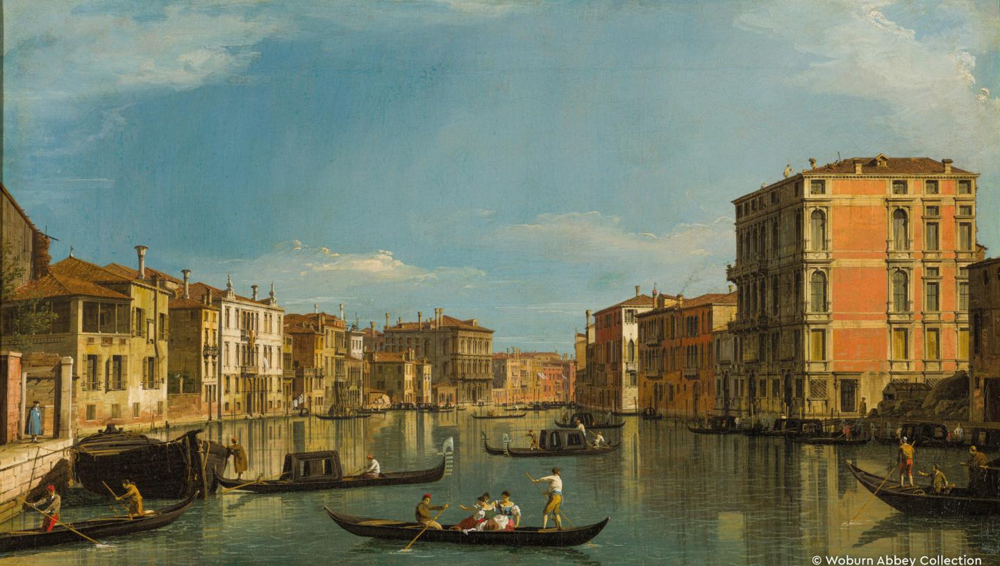 gondoliers punting with buildings on each side and sky above
