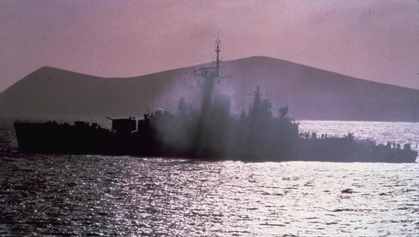 Historic photograph of Royal Navy ship HMS Plymouth on fire after an air attack during the Falklands War