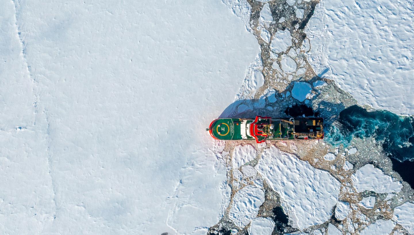 An overhead view of polar research ship Sir David Attenborough breaking through the ice