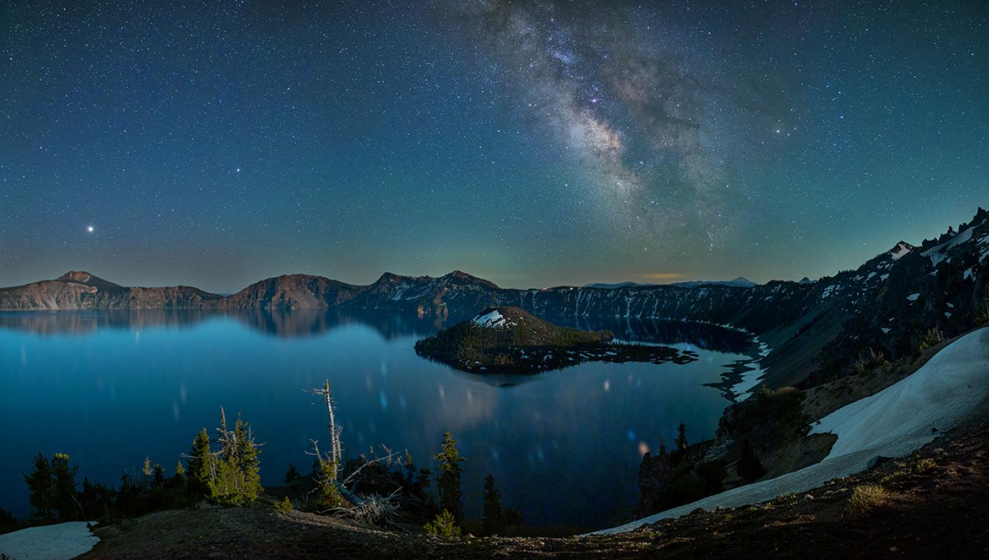 Milky Way stretches above a mountainous lake