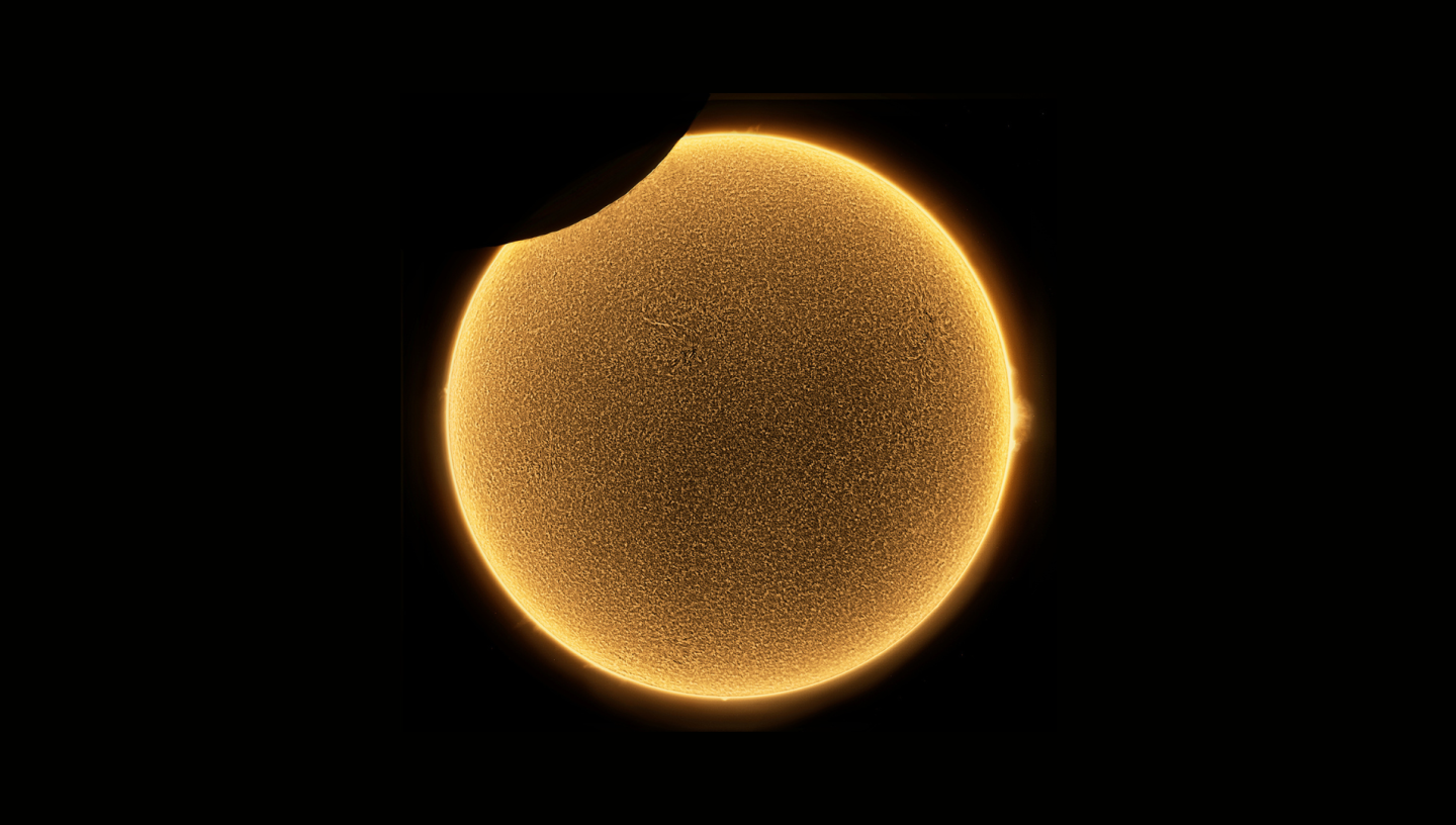 Image of Sun which is dark gold in the centre and light gold on the edges, with a small black semicircle missing from top left corner