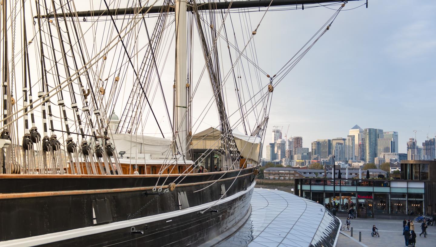 A shot with the Cutty Sark on the left hand side, facing Canary Wharf in the background