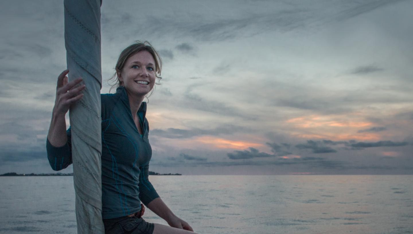 Emily Penn standing on deck of ship at sunset