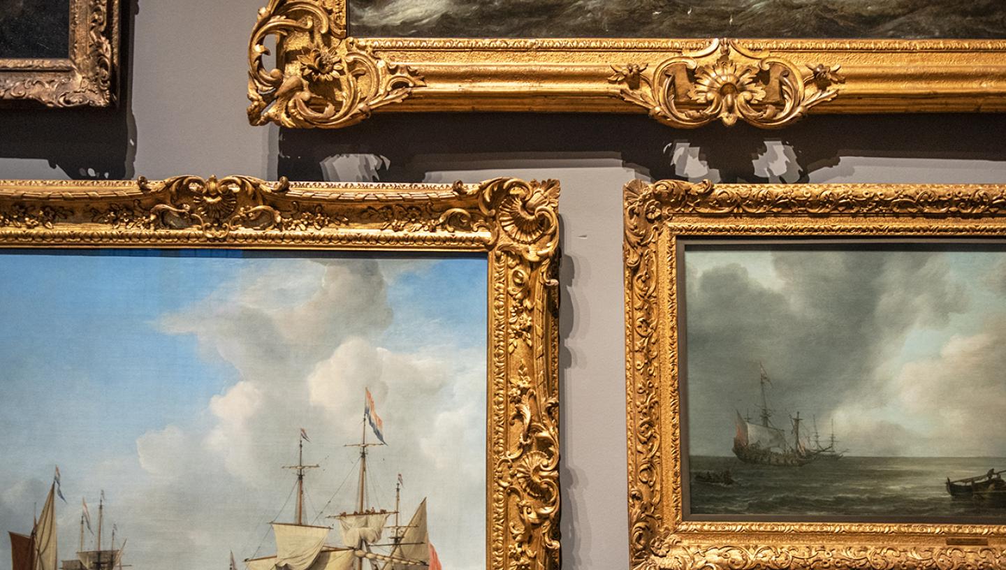 A group of paintings on display at the Queen's House in Greenwich. The image focuses on their burnished gold frames, creating a pleasing geometric pattern on the wall