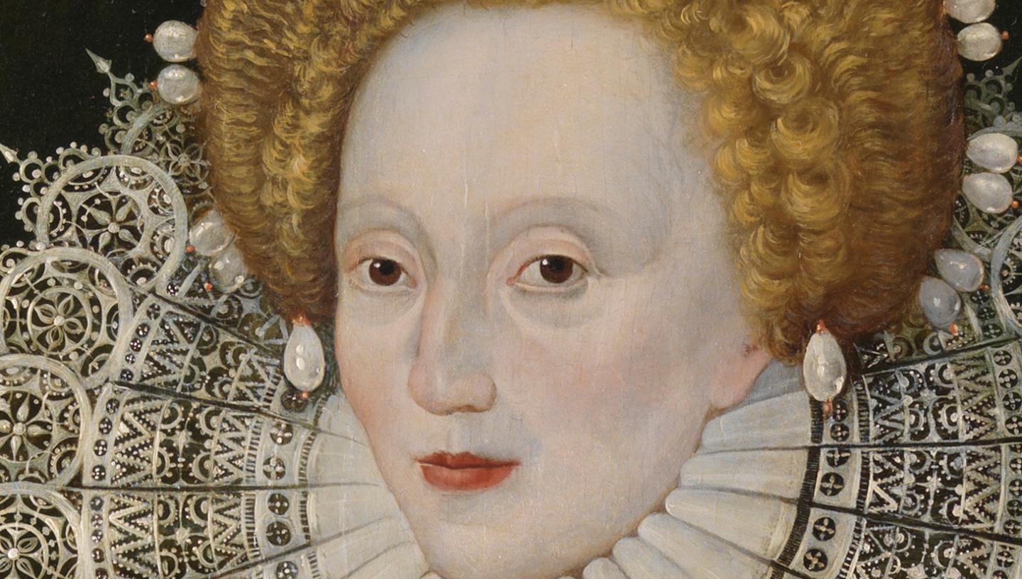A close-up view of part of a painting of Queen Elizabeth I, showing her pale oval face framed by a crop of ginger hair and delicate lace ruff