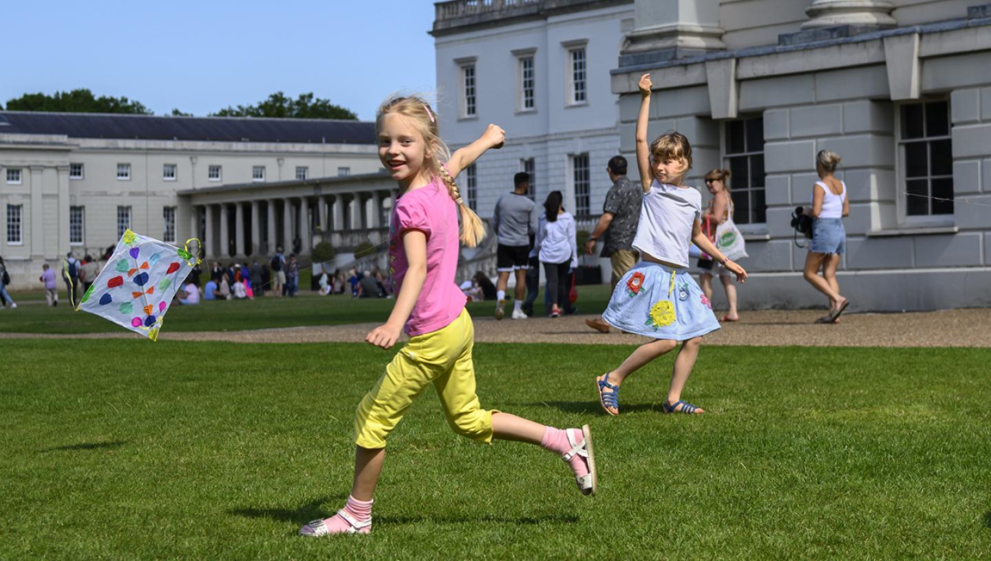 A child flies a kite outside the National Maritime Museum 