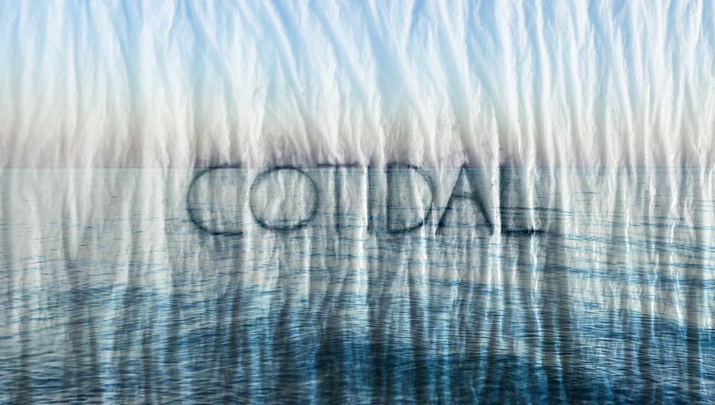 A still from a film trailer. A photo of a calm sea has been overlaid with a paper texture effect, and the word 'COTIDAL' embossed on top
