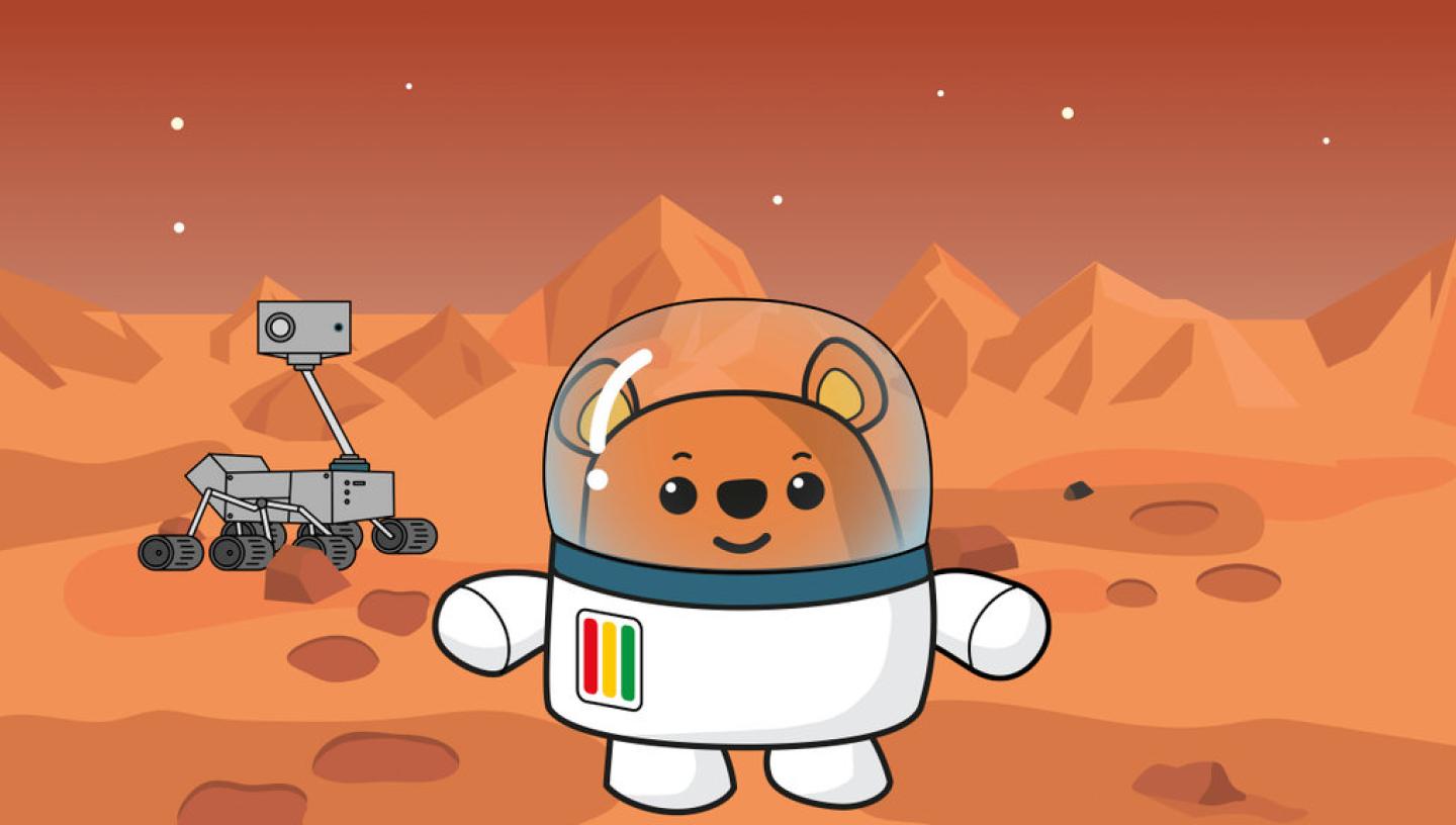 Ted the bear is stood on Mars, with a Martian rover behind him.