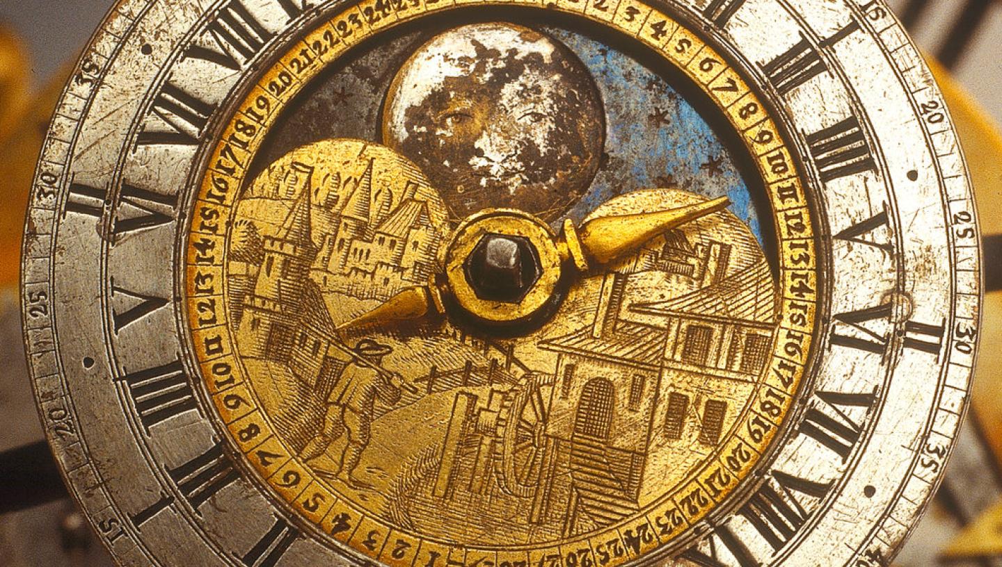 Detail of a celestial clockwork globe, showing a clockface with Roman numerals around the dial