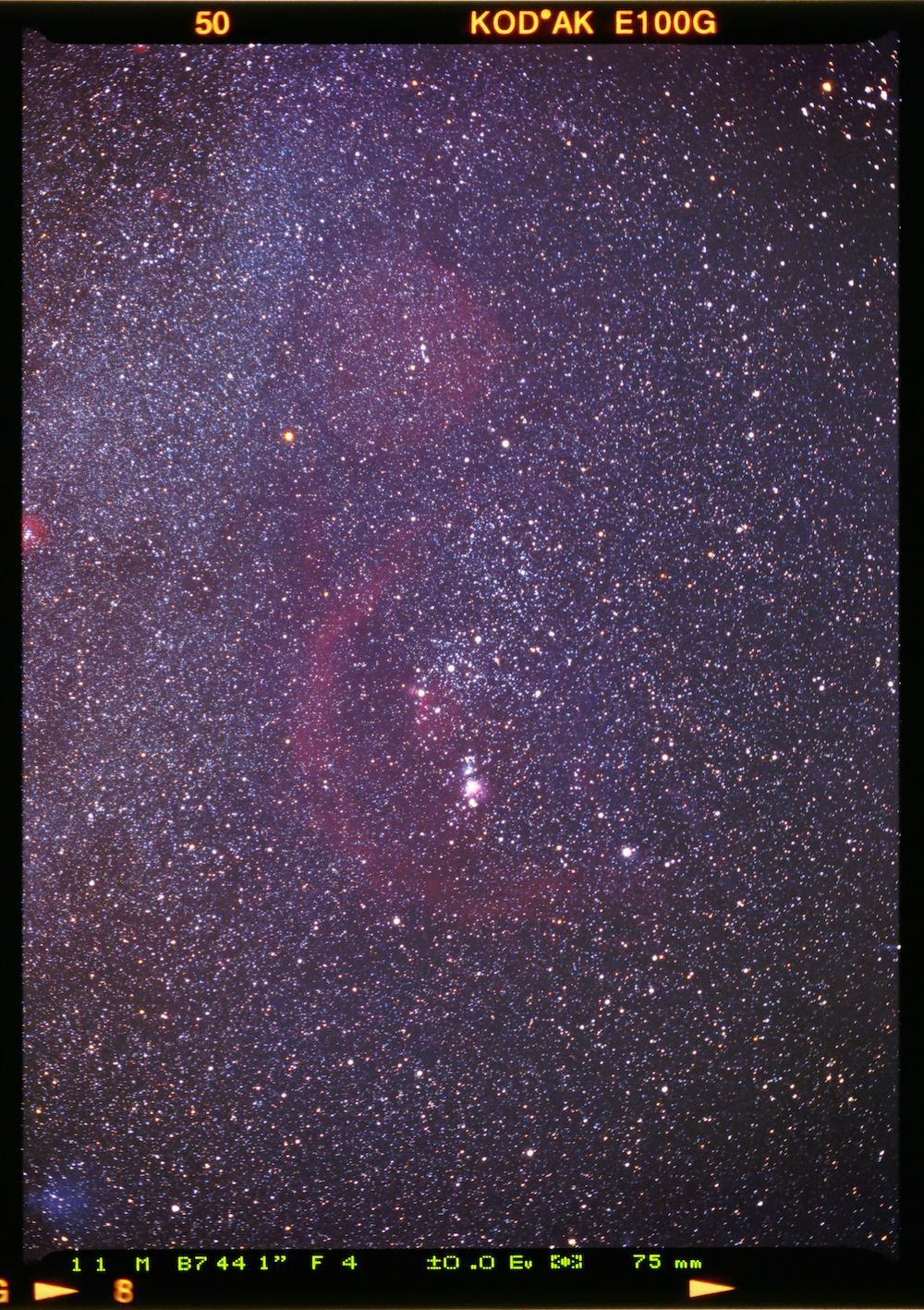 An image showing ''Slide' to the past - Orion Constellation and its nebulas on positive film'